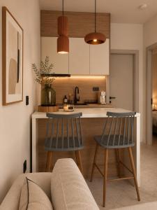 a kitchen with two chairs and a table in a room at Noema Park View in Xanthi
