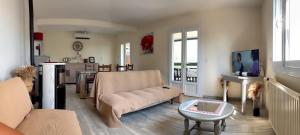 a living room with a couch and a table at Gîte Chez Clara in Rocamadour
