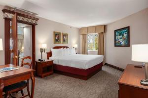 a hotel room with a bed and a desk at Bayshore Resort in Traverse City +84 photos