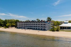 a hotel on the beach next to the water at Bayshore Resort in Traverse City