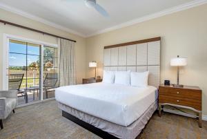 a bedroom with a large bed and a balcony at WorldMark Reunion in Kissimmee