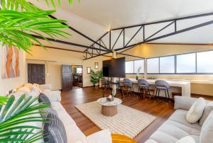 a living room with couches and a dining room at Palmcove Chiang Mai Old Town in Chiang Mai