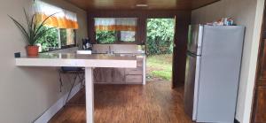 a kitchen with a white counter and a refrigerator at Bosque Alto Lodge in Platanal