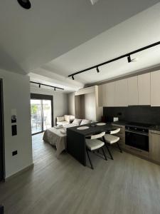 a living room with a bed and a table and chairs at Tsonas Maisonette in Lygia