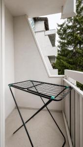 a glass table on a balcony with stairs at Золотые пески in Bosteri +15 photos