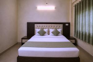 a bedroom with a large bed with white sheets and pillows at Hotel Galaxia Inn Near PEC College in Chandīgarh