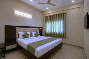 a bedroom with a large bed and a window at Hotel Galaxia Inn Near PEC College in Chandīgarh