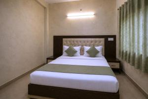 a bedroom with a large bed with white sheets and pillows at Hotel Galaxia Inn Near PEC College in Chandīgarh +16 photos