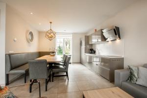 a kitchen and dining room with a table and chairs at Group accommodation 123 in Valkenburg