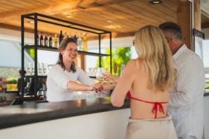 a woman standing at a counter in a bar at Group accommodation 123 in Valkenburg +28 photos
