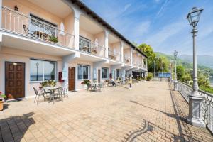 a courtyard of a building with tables and chairs at Studio 2- lake view in Oggebbio