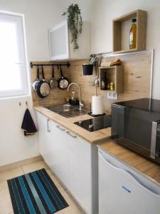 a kitchen with a sink and a counter top at Studio Terrasse - Parking gratuit in Orléans
