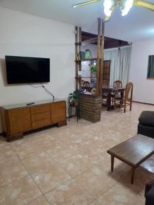 a living room with a flat screen tv on the wall at Casa del centro in San Martín