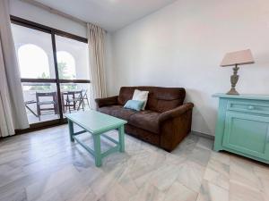 a living room with a couch and a table at Vistahermosa Gestur Apartamentos in El Puerto de Santa María +164 photos