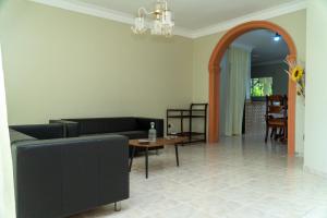 a living room with a couch and a table at bohiostay in Azua