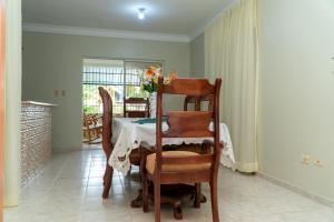 a dining room with a table and chairs with a table and a table at bohiostay in Azua