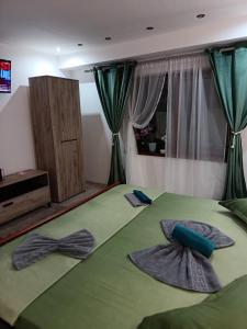 a bedroom with two bow ties on a bed at Casa Cristyana in Orşova +61 photos