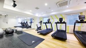 a gym with treadmills and ellipticals in a room at Holiday Inn Express Sapporo Susukino by IHG in Sapporo