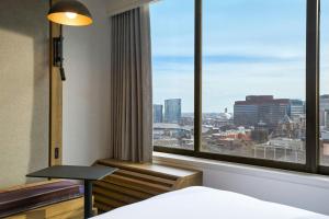 a hotel room with a large window with a view at Sheraton Philadelphia University City Hotel in Philadelphia +47 photos