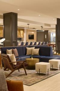 a living room with a blue couch and chairs at Sheraton Philadelphia University City Hotel in Philadelphia