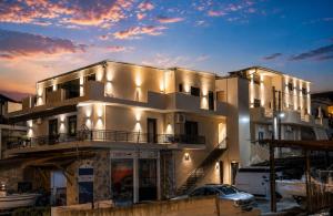a large white building with a marina at Estia Luxury Suites & Spa in Platamonas