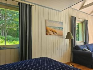 a bedroom with a bed and a couch and a window at Väänavilla Romantic Getaway in Vääna-Jõesuu