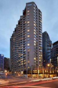 a tall building with lights on in a city at Delta Hotels by Marriott Montreal in Montreal +71 photos