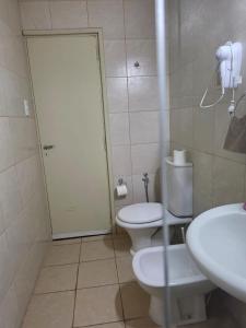 a bathroom with a toilet and a sink at Casa del centro in San Martín +17 photos
