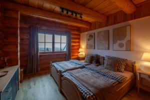 a bedroom with a bed in a log cabin at Srub Chodov in Chodov +41 photos