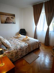 a bedroom with a bed and a window at Apartman Ivona in Zadar