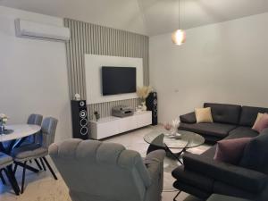 a living room with a couch and a tv at Sea you in Bar in Bjeliši