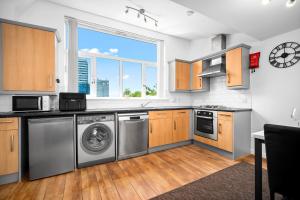 a kitchen with a washer and dryer in it at Providence Suites 1 Bedroom Sleeps 4 Perfect for Contractors and Families and Solo Travellers in Fallings Park