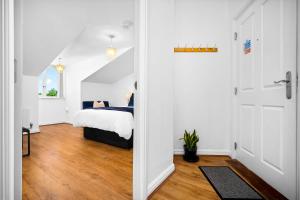 a bedroom with a bed and a door leading into a room at Providence Suites 1 Bedroom Sleeps 4 Perfect for Contractors and Families and Solo Travellers in Fallings Park