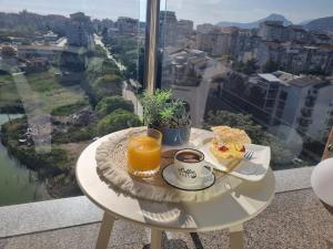 a table with a plate of food and a cup of orange juice at Sea you in Bar in Bjeliši +3 photos