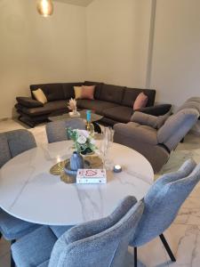 a living room with a table and a couch at Sea you in Bar in Bjeliši