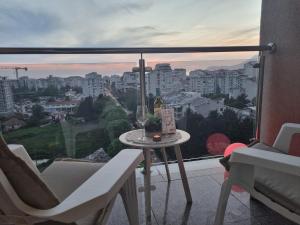 a balcony with a table and chairs and a view of a city at Sea you in Bar in Bjeliši