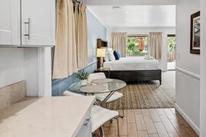 a hotel room with a bed and a table at Inn by the Harbor in Santa Barbara +39 photos