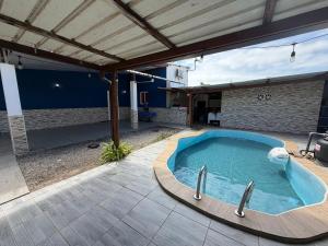 a swimming pool in a yard with a patio at La Villa La ri Deye in Kourou +5 photos