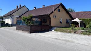 a house with a garage on the side of a street at Apartma Rožman in Radenci