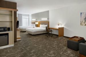 a hotel room with two beds and a desk at Springhill Suites by Marriott Detroit Metro Airport Romulus in Romulus +36 photos