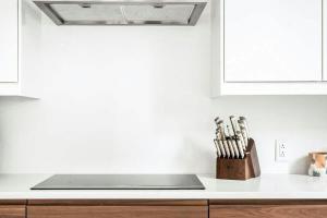 a kitchen with a counter top with a knife block at Rooftop Condo in Nashville