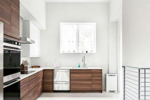 a kitchen with wooden cabinets and a sink and a window at Rooftop Condo in Nashville