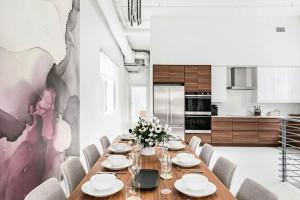 a dining room with a long table and chairs at Rooftop Condo in Nashville +12 photos