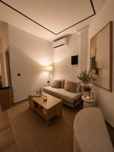 a living room with a couch and a table at Noema City View in Xanthi