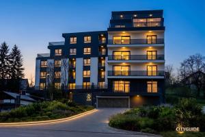 a large apartment building with its lights on at Emma Luksuzni apartman Tuzla Musique in Tuzla