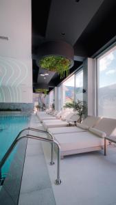 a row of beds in a room with a pool at Motel Predejane in Predejane
