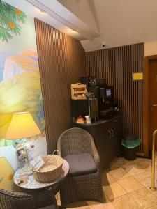 a room with a table and a chair and a desk at Hotel am Schloss - Frankfurt an der Oder in Frankfurt Oder