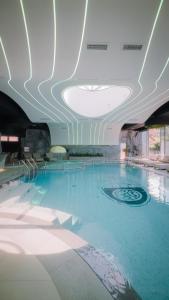 a large swimming pool in a building with a ceiling at Motel Predejane in Predejane +79 photos