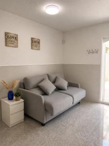 a living room with a couch in a room at Little Los Emilios in Torrevieja