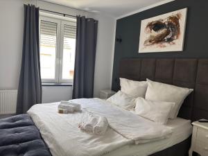 a bedroom with a bed with two stuffed animals on it at Hotel Zur Krone in Nordwalde